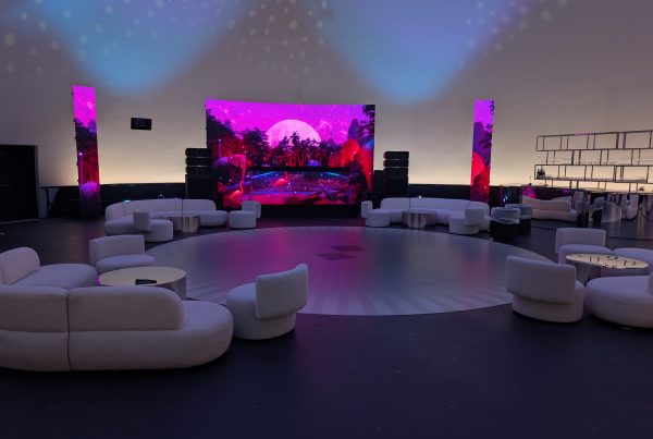 Modern-looking couches and chairs are set up for an event in a large planetarium.