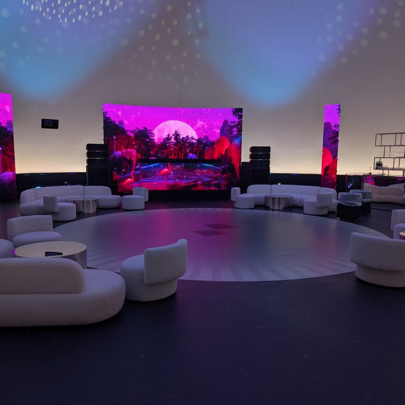 Modern-looking couches and chairs are set up for an event in a large planetarium.