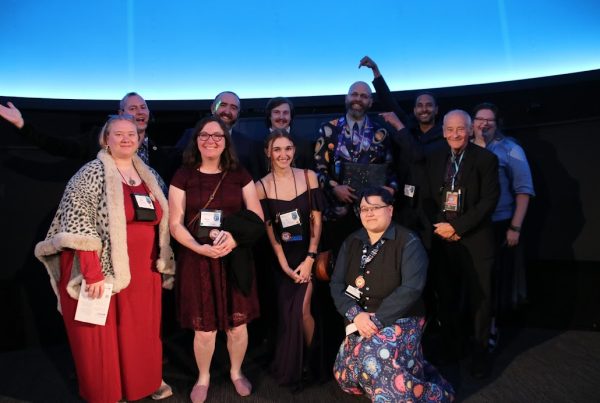 Image showing group of folks in a planetarium, dressed nicely.