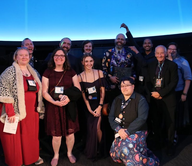 Image showing group of folks in a planetarium, dressed nicely.